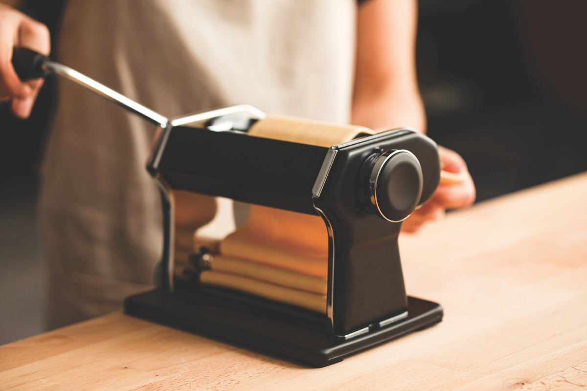 Image of Simone Agostino rolling egg pasta sheets form her cookbook TOO.