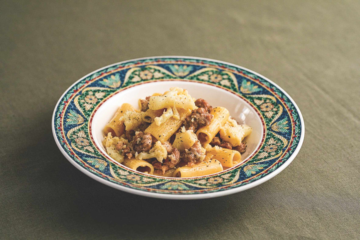 image of pasta gaggiata dish from The Table of Us cookbook, by Simone Agostino. Rigatoni with cauliflower and pork and fennel sausage.