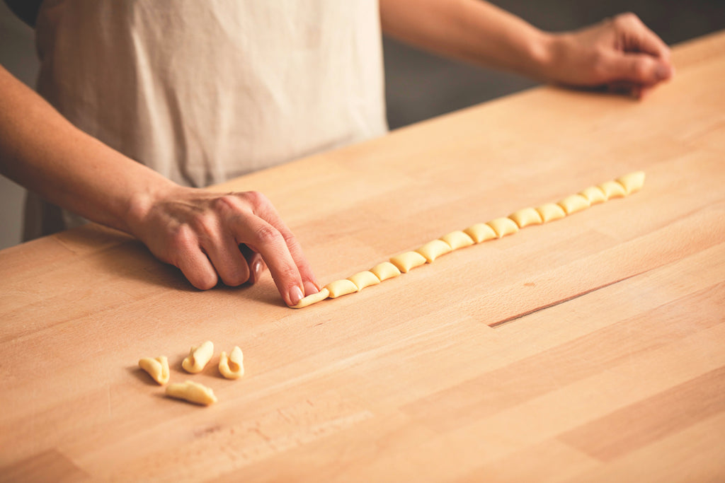 Image of Simone Agostino shaping fresh cavatelli semolina pasta shape. Image from her cookbook TOO.