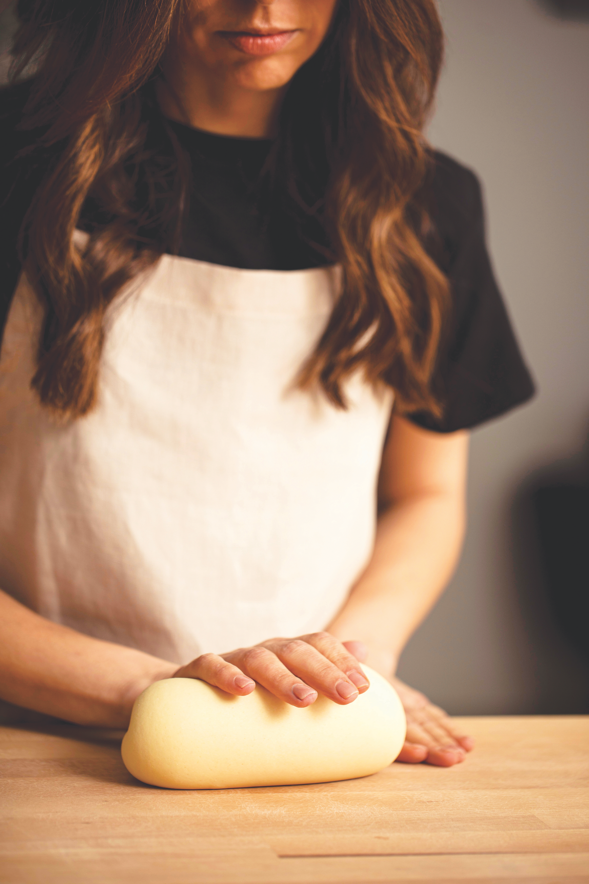 Picture of Simone Agostino hand kneading an egg pasta dough. Image from her cookbook TOO.