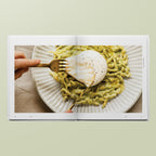 Double page spread of Simone Agostino's hands bursting open a burrata nestled onto of her trofie with a zucchini cream pasta dish, from her cookbook TOO.